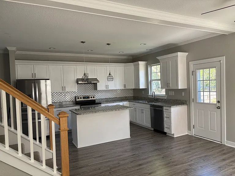 View of kitchen and access to backyard from dining room