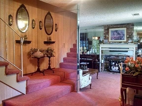 Don't let the mirrors fool you. There is only one stairway. To our right is the living room and one 