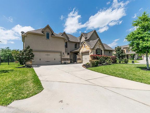 Beautiful front elevation features dual wide driveway, 3-car garage, gorgeous stucco and stacked stone.