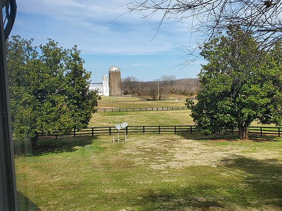 The view outside the rear side of the apartments. The satellite discs are pre-wired for DirecTV or Viasat. The view is more of the farm land.