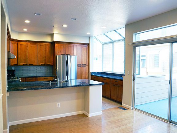 Remodelled kitchen, dining room, and view of back deck