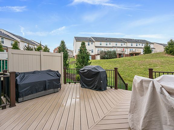 Large Trex deck off family room
Grill, 4-person dining table & modular couch. Steps down to lawn area.