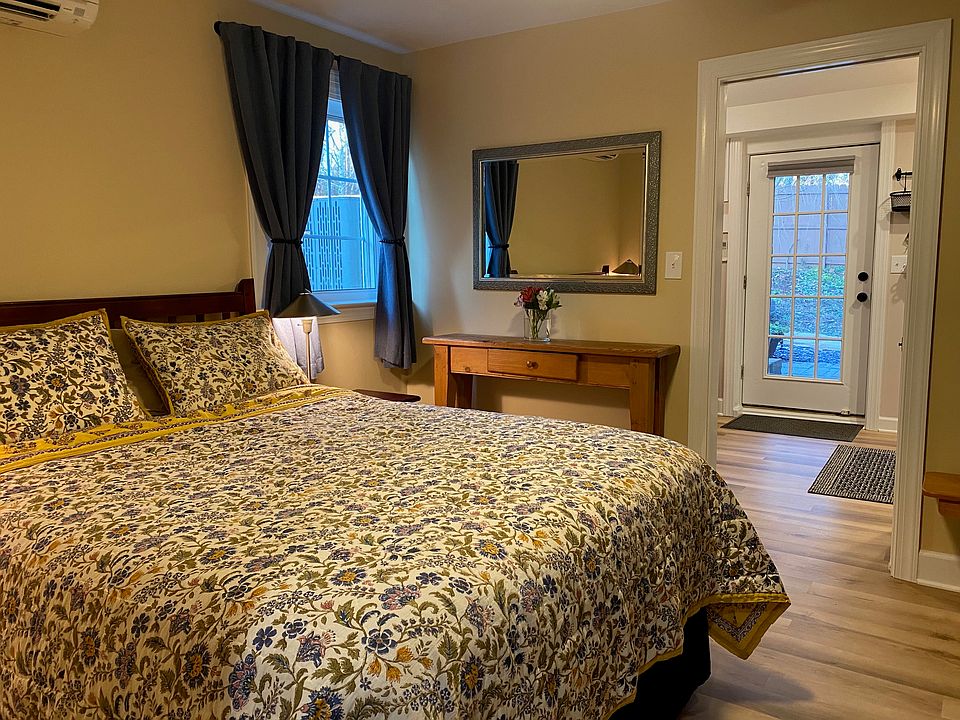 Bedroom into kitchen. Window has a blind as well as black out curtains.