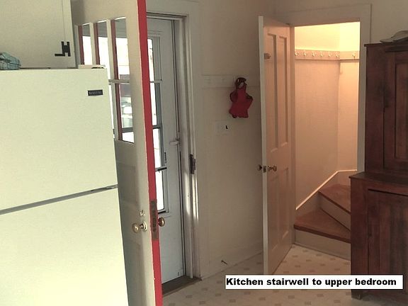 Door to upstairs bedroom from kitchen, first floor bath to right as well as entry to basement
