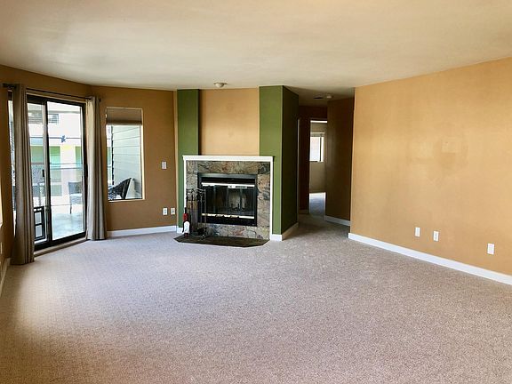 Living room, wood burning fireplace, patio access