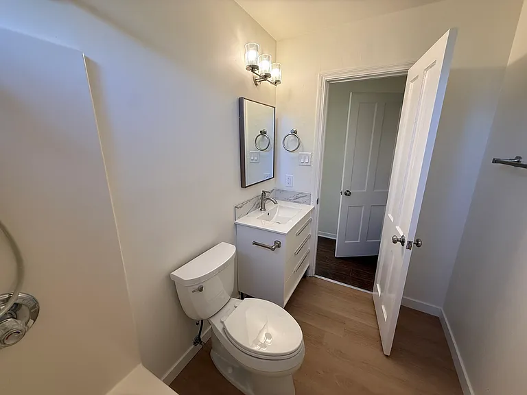 The hallway bathroom is tastefully appointed updated fixtures.