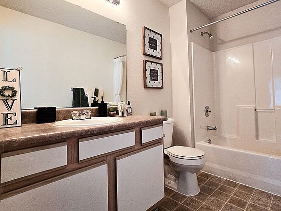 Well-Lit Bathrooms with Granite-Style Countertops