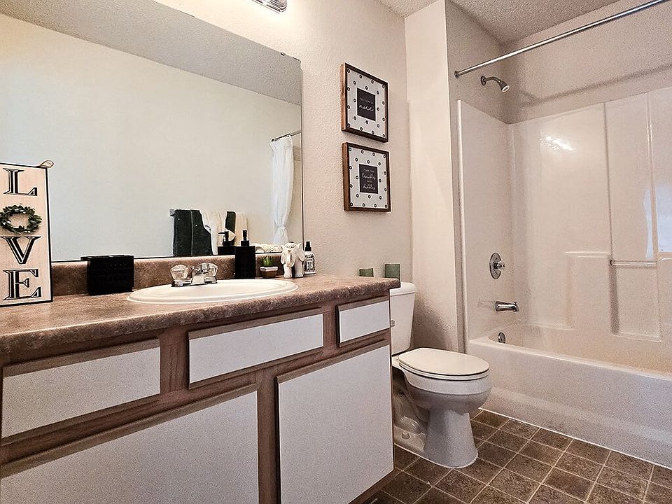 Well-Lit Bathrooms with Granite-Style Countertops