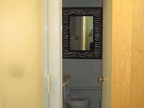 Half moon shower is attached to separate sink & toilet area. The two doors in this photo show how private the "water closet" can be.