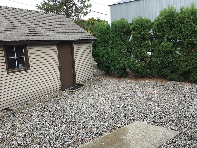 Back yard showing edge of garage