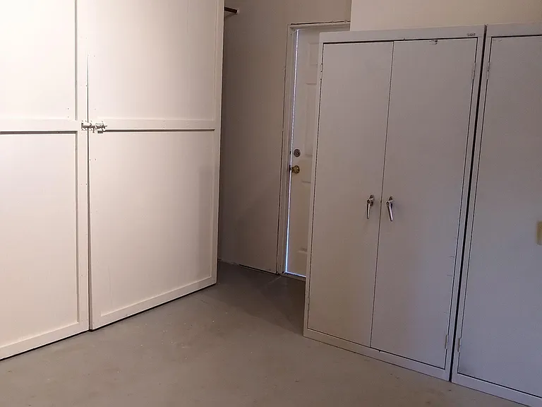 12' x 12' storage room with shelving units.