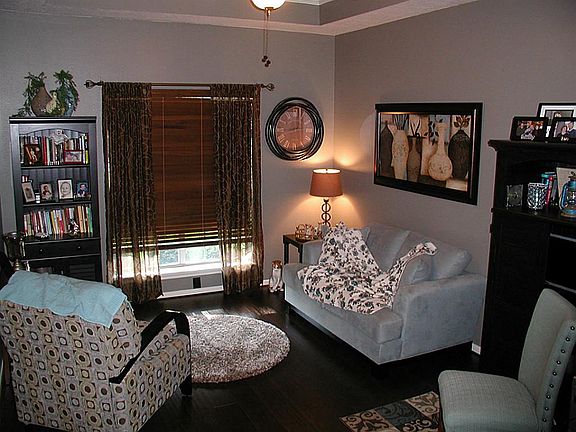 As you enter this lovely home, a formal sitting area with high coffered ceiling, ceiling fan and lam
