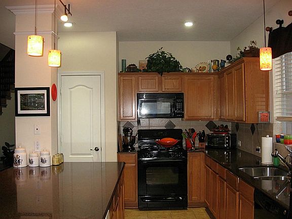 Another view of the kitchen.  Gas cooktop and oven. Tile floors in the kitchen also.