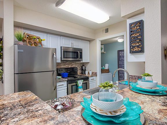 Contemporary kitchens with breakfast bars, ideal for casual dining or entertaining. Laundry room is located next to the kitchen.