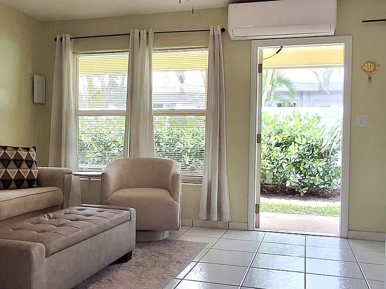 unit is on the first floor with private entrance and chairs in front of the unit