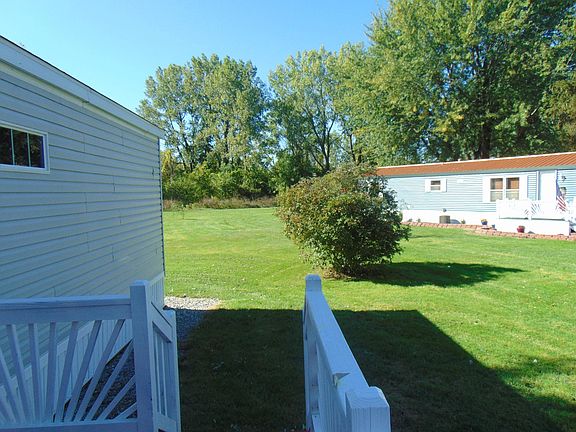 Looking towards the back of this home you can not help but notice the beautiful woods in the background. Spend some of your evenings sitting on the deck watching the wild life.