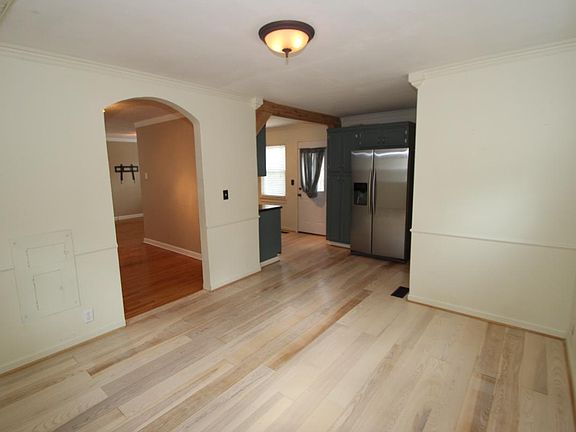 View of kitchen from dining room. To the right of the refrig