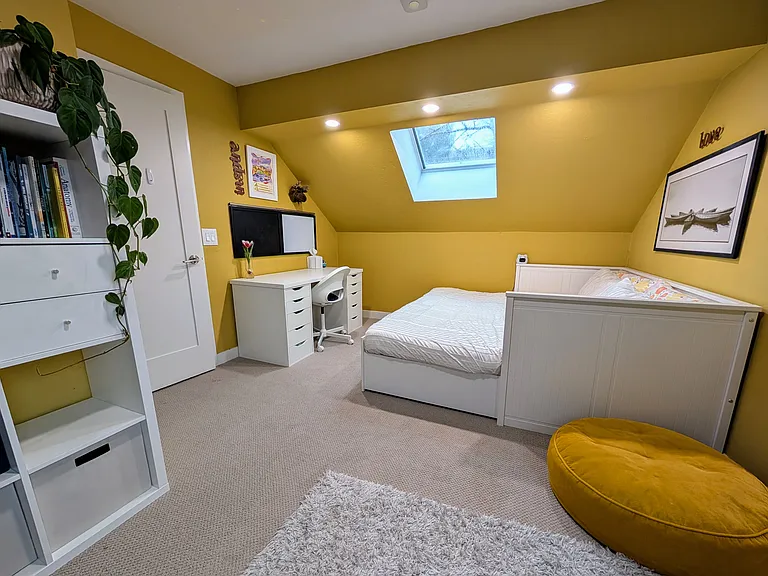Upstairs Bedroom 1 - King bed that can be converted into a single daybed, desk, bookshelf, large closet and skylight.