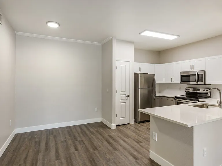 Modern kitchen with white cabinetry and stainless steel appliances