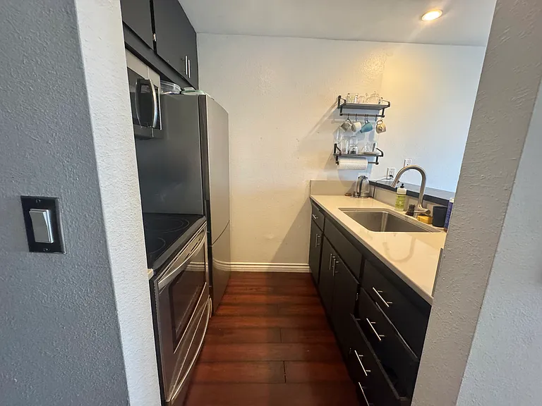Brand new quartz countertops and large sink in the modern kitchen.