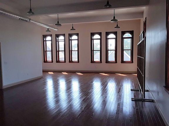 Facing the south windows.