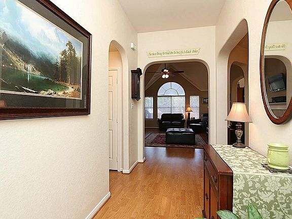 Welcoming foyer area featuring laminate floors opens up to living room.