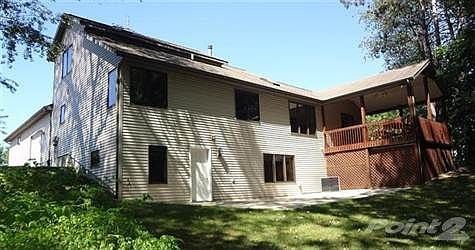 Walkout lower level with a large patio leads to the private backyard, surrounded by beautiful mature trees, overlooking the ravine on Yellow Creek.