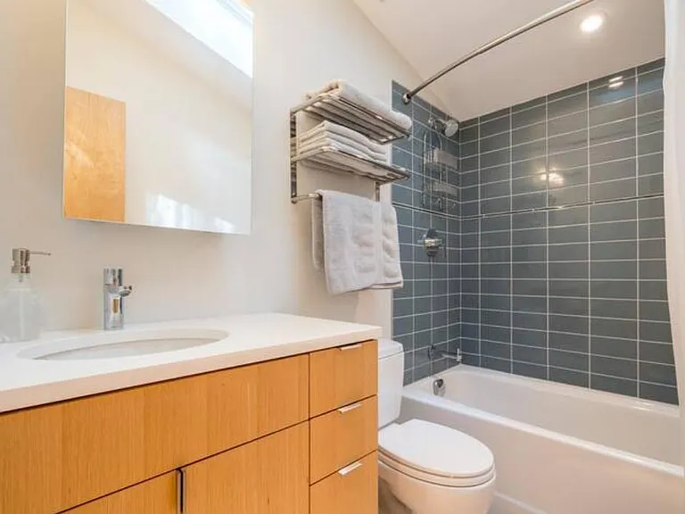 The bathroom has lots of storage, a full-size tub and shower, and (not shown) a skylight. NOT included: towels