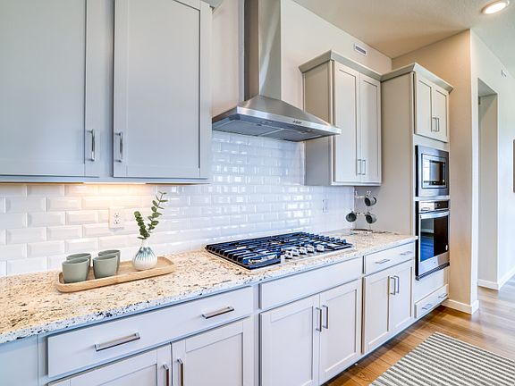 The stylish and functional kitchen features built-in, stainless steel appliances throughout.