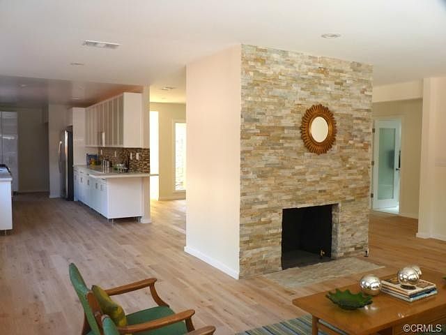 The front livingroom fireplace is tiled with quartz. The atruim