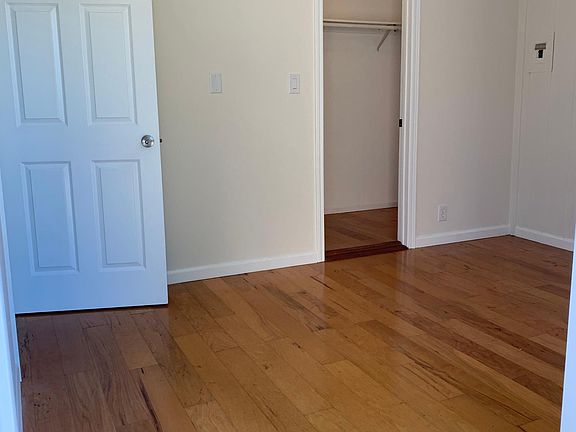 Bedroom 2 or great office space. Has a walk in close, room is 12'3" x 9'3" Hardwood floors new ceiling light, doors and blinds.