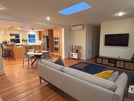 Living, dining and open kitchen with 2 sky lights