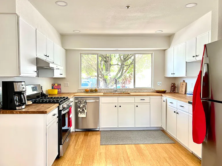 Kitchen with butcher-block countertops and stainless steel appliances