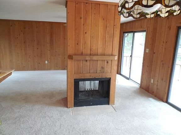 Open living room and dining room floor plan. Full view of the lake from all angles. Wood burning fire place.