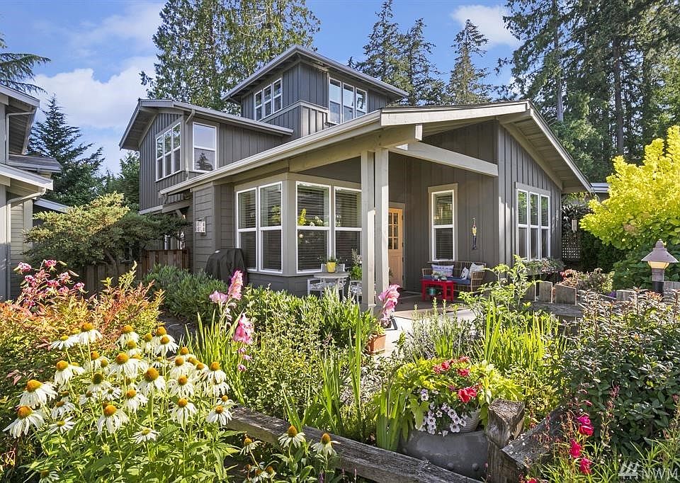 Enjoy the beautiful flower gardens as you approach the home.