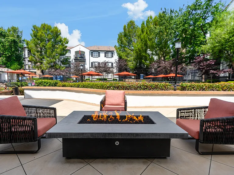 Community Patio Area with Cushioned Chairs and Modern Fire Feature