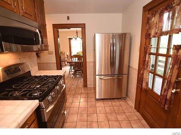 Updated kitchen with stainless steel appliances and door to wrap around deck.