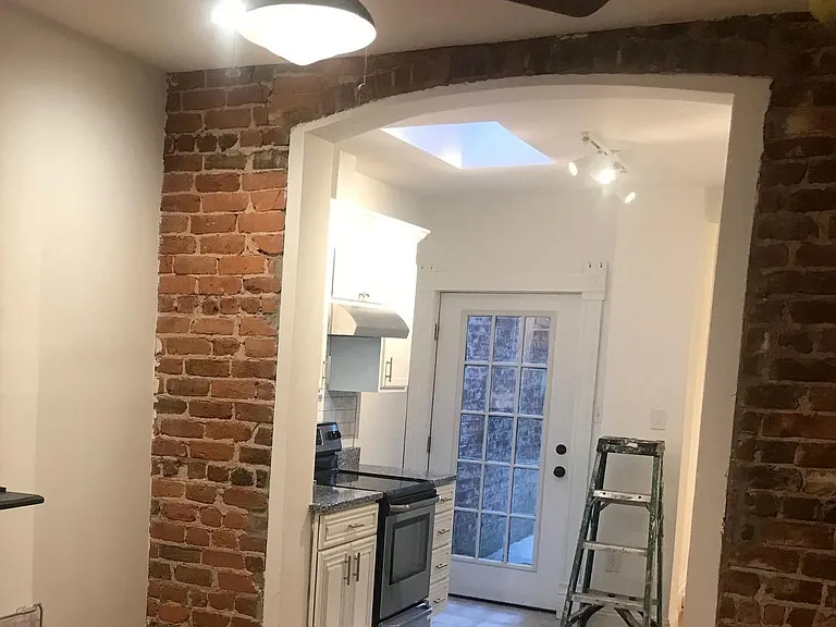 View from the living room into the kitchen. Door enters on to the back deck. Note the skylight (sorry about the ladder OOPS!)