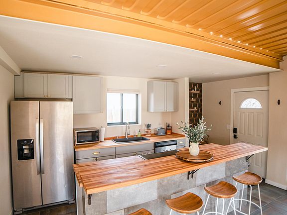 Kitchen with massive Island and entertaining area. Exposed golden ceilings!