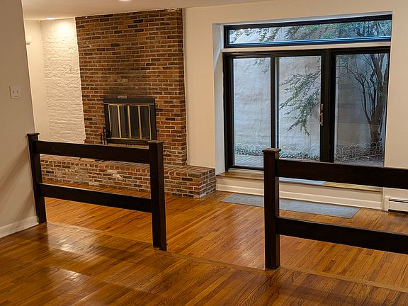 Living room with (decorative) fireplace and glass doors to private patio
