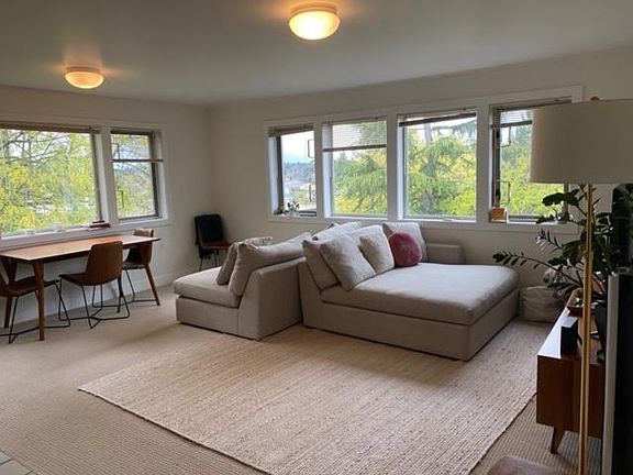 Living/dining area with view and wood burning fireplace.