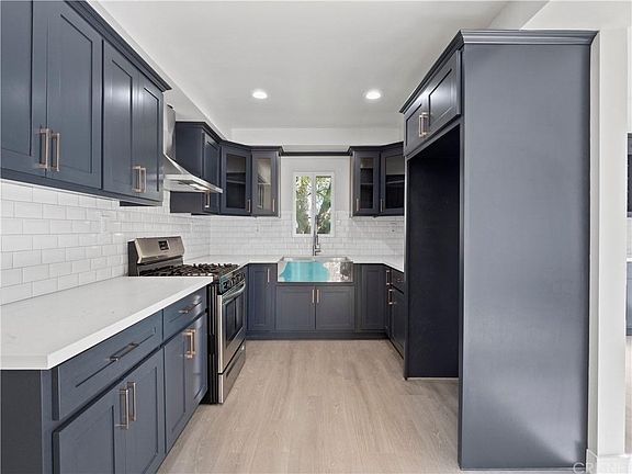 Kitchen with tons of storage, subway tile, granite countertops, stainless appliances, huge sink, garbage disposal, and more outlets than you'd ever need