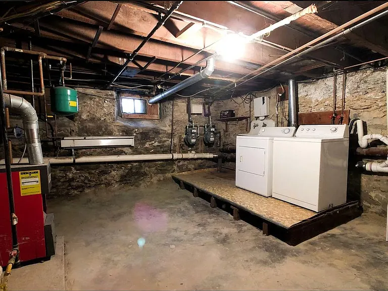 Convenient private washer and dryer in the basement, with plenty of space for personal storage.