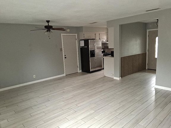 An overview of the living room and kitchen as shown from the backdoor side of the room. This room is 20'x16'