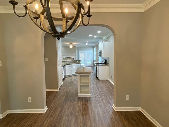 View of kitchen from dining room. Kitchen has a movable island.