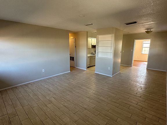 Open plan living room flows into either dining room or kitchen.