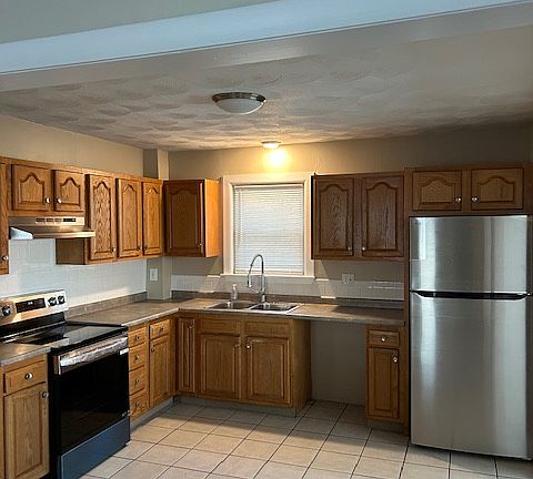 large kitchen with new LG stainless fridge and stove