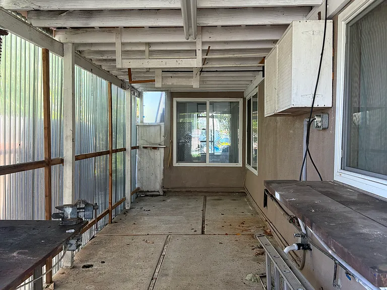Covered workshop area - man cave or craft, toy area
Side of back yard.