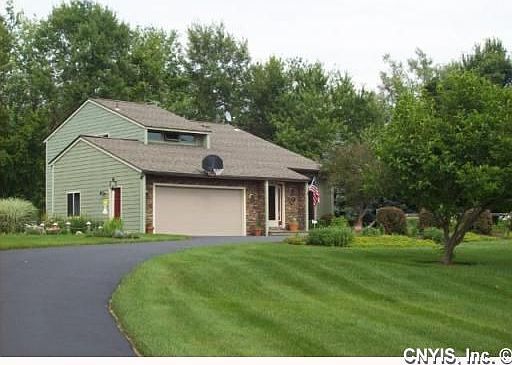 Custom stone facade, gorgeous landscaped 3 acre setting.