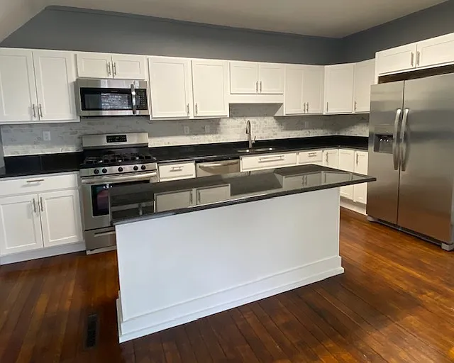 Recently remodeled kitchen with stainless appliances, including stove, microwave, refrigerator and dishwasher